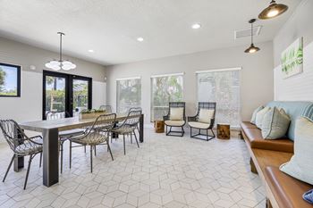 resident clubhouse with tables, chairs, and booths